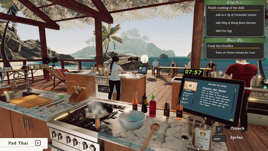 Screen z gry Cooking Championshimps przedstawia widok na kuchnię znajdującą się na plaży na tropikalnej wyspie. Na pierwszym planie kuchenka z patelnią i gotującym się na niej daniem, obok miska i jakieś butelki. Widać też ekran z recepturą tworzonej potrawy.